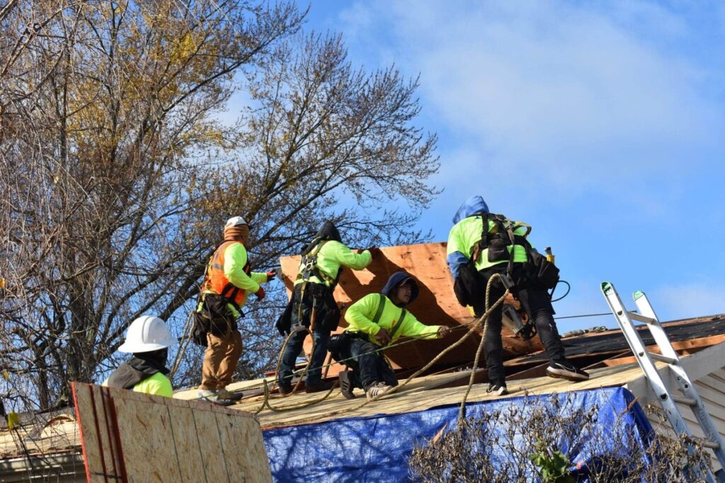 Crew of roofers replacing residential roof