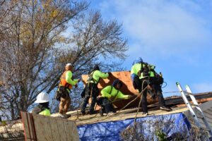 Crew of roofers replacing residential roof